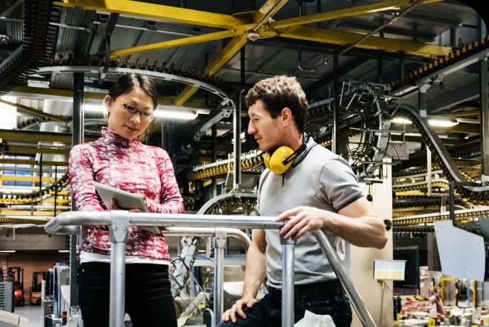 Engineer talking to the manager at production factory.